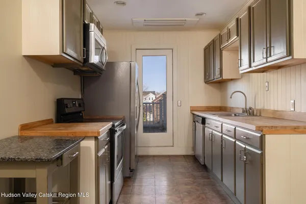 a kitchen with stainless steel appliances granite countertop a sink stove and cabinets