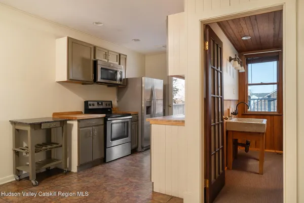 a kitchen with stainless steel appliances a stove microwave and refrigerator