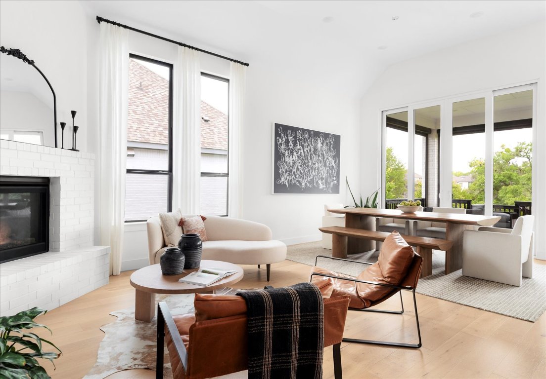 482 Running Bird Road Austin, TX 78737 - Photo 12 of 38 Keeping room with plenty of natural light, a brick fireplace and high ceilings.