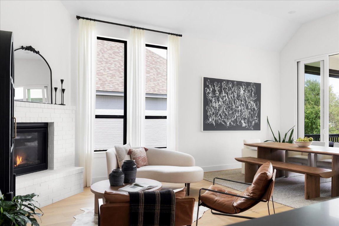 482 Running Bird Road Austin, TX 78737 - Photo 13 of 38 Keeping room with plenty of natural light, a brick fireplace and high ceilings.