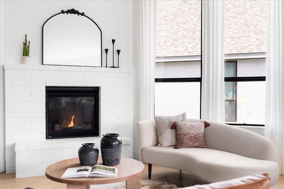 482 Running Bird Road Austin, TX 78737 - Photo 15 of 38 Keeping room with plenty of natural light, a brick fireplace and high ceilings.