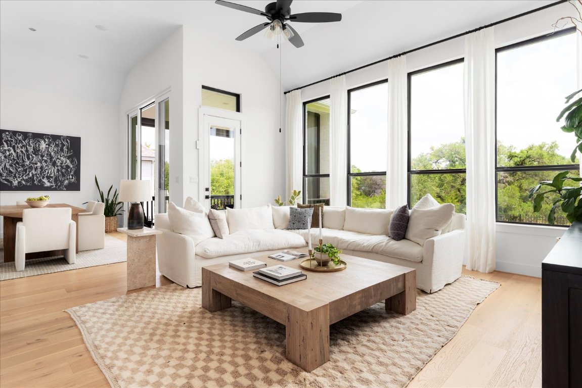 482 Running Bird Road Austin, TX 78737 - Photo 17 of 38 An oversized living room with custom window treatments and serene greenbelt views the perfect place to entertain or unwind.
