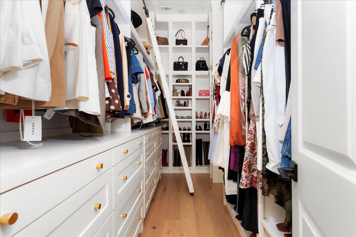 482 Running Bird Road Austin, TX 78737 - Photo 26 of 38 An impeccably designed closet with floor-to-ceiling custom builds, jewelry drawers, cubbies, and space for everything you could want.
