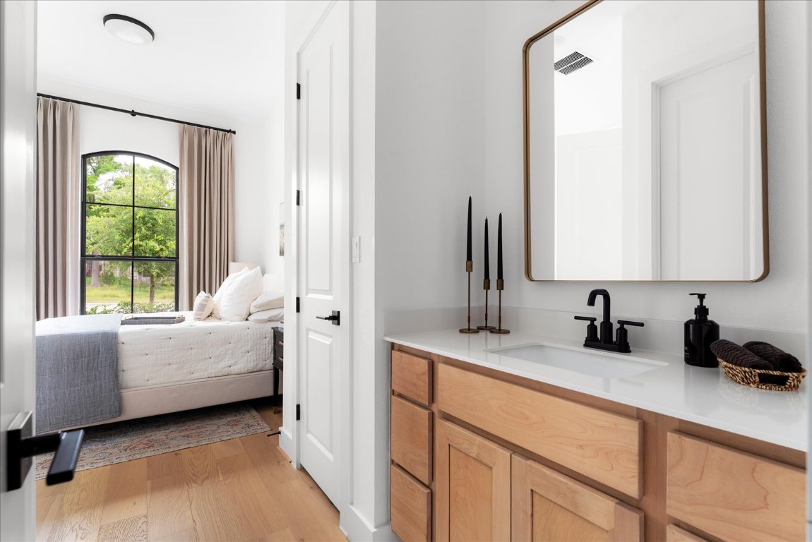482 Running Bird Road Austin, TX 78737 - Photo 27 of 38 This Jack and Jill bedroom features a private sink area right inside the room, with easy access to the shared bath through separate doors.