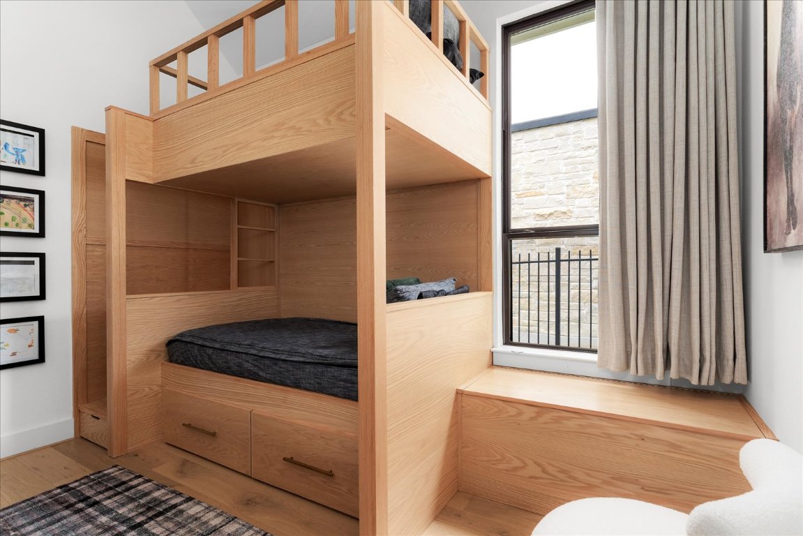 482 Running Bird Road Austin, TX 78737 - Photo 31 of 38 Perfect for family living — this bedroom includes a custom bunk bed with built-in storage and custom shades to complete the look.