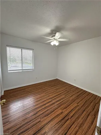 a view of a room with wooden floor and white walls