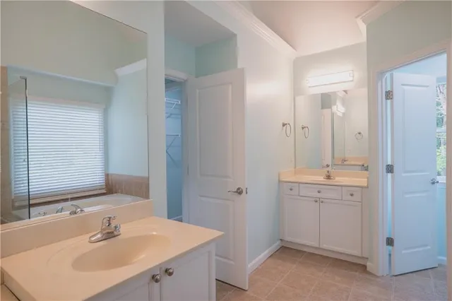 a bathroom with a sink double vanity and a mirror