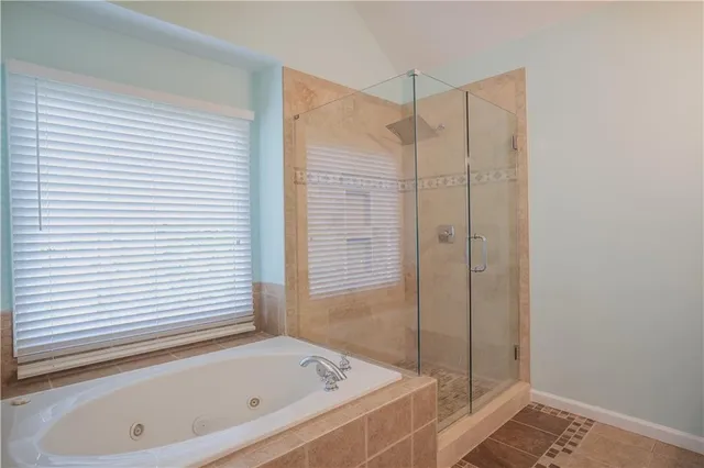a bathroom with a tub and a shower