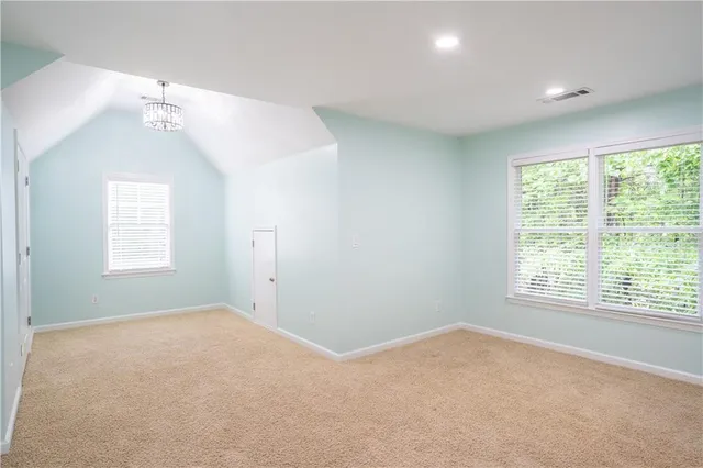 an empty room with windows and closet