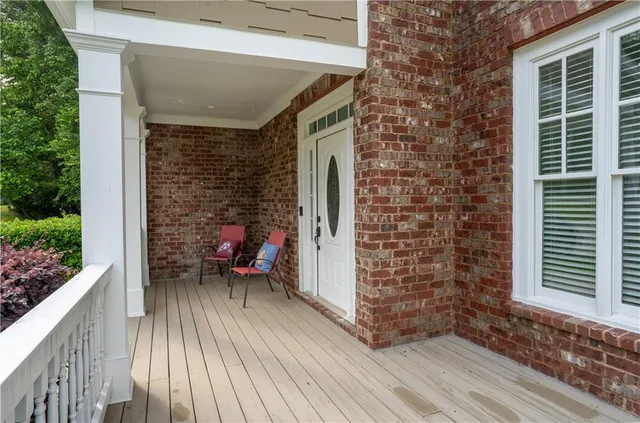 a balcony with furniture and a potted plant