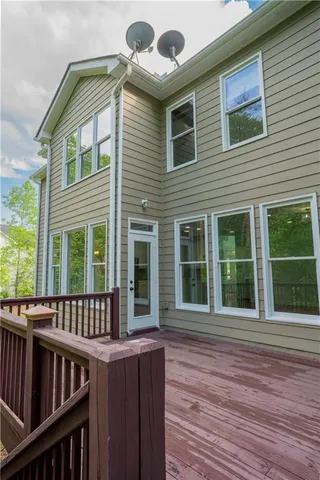 a view of a house with wooden deck