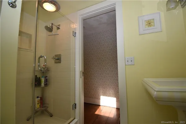 a bathroom with a granite countertop shower and a toilet