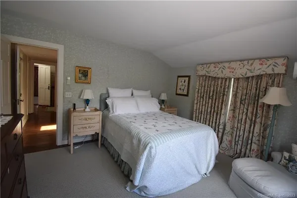 a bedroom with a bed and chair
