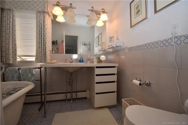 a bathroom with a sink mirror vanity and toilet