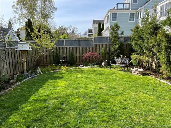 a view of a house with backyard and sitting area