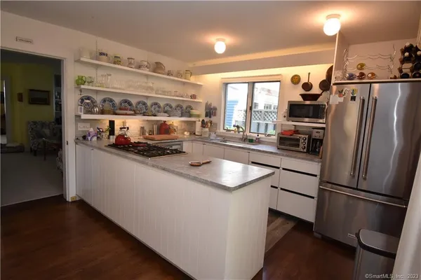 a kitchen with stainless steel appliances a sink and a refrigerator