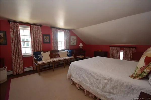 a spacious bedroom with a bed and a couch