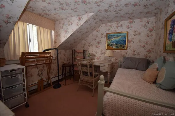 a bedroom with furniture and a window