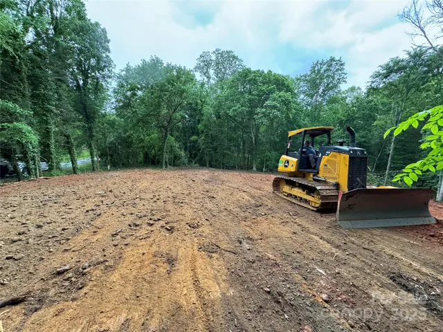 a wooden bench sitting in the middle of a yard