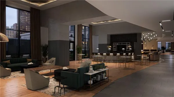 a living room with furniture a flat screen tv and kitchen view