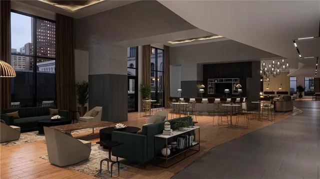 a living room with furniture a flat screen tv and kitchen view