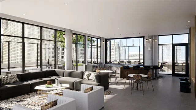 a living room with furniture and floor to ceiling windows