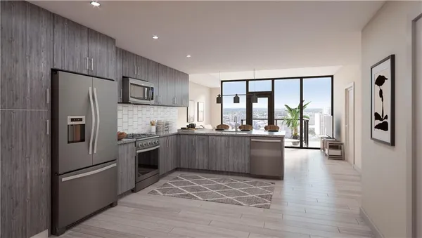a kitchen with a refrigerator and a stove top oven