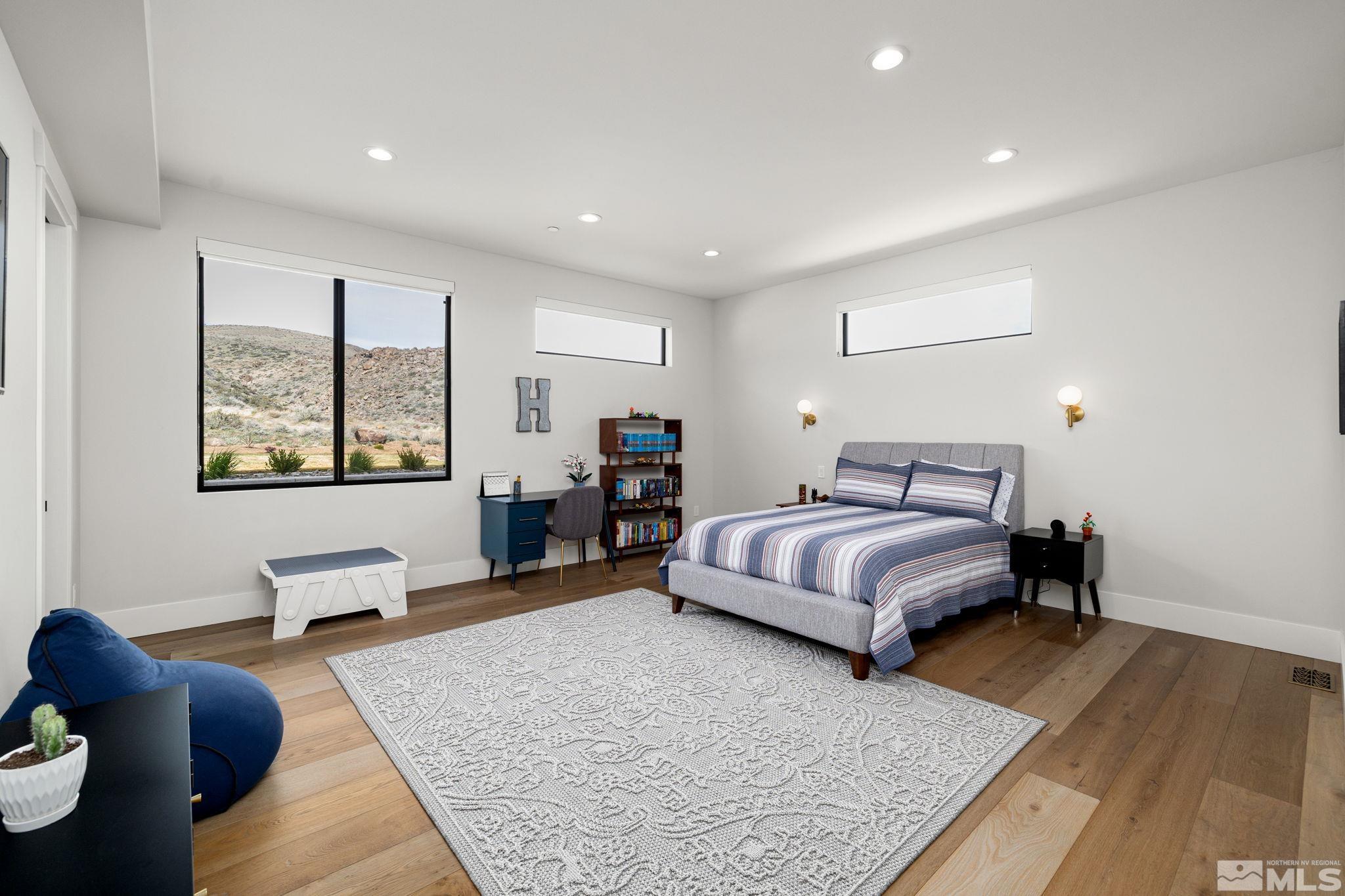 4225 Drop Tine Court Reno, NV 89511 - Photo 11 of 14 a spacious bedroom with a bed and wooden floor