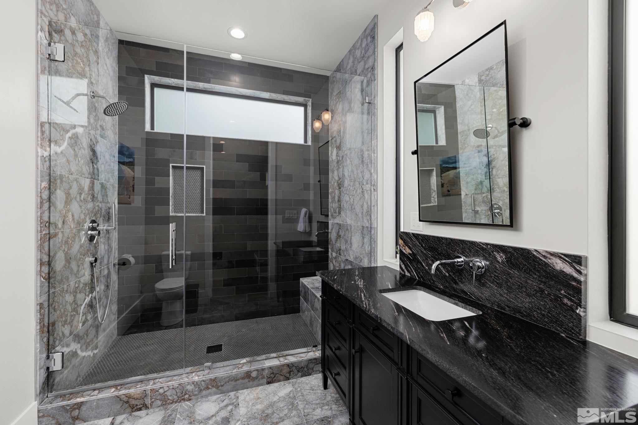 4225 Drop Tine Court Reno, NV 89511 - Photo 12 of 14 a bathroom with a granite countertop sink a mirror and shower