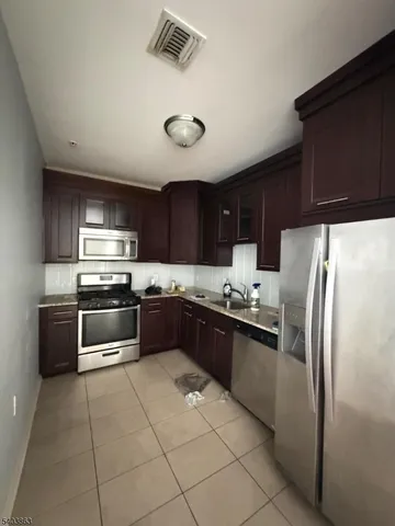 a kitchen with stainless steel appliances and cabinets