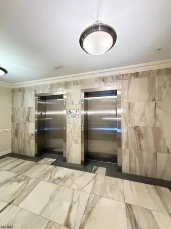 a kitchen with granite countertop a refrigerator and a sink