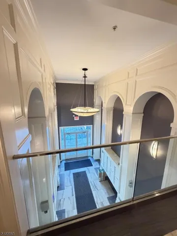 a view of a hallway with a chandelier