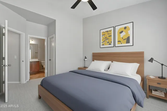 a bedroom with a bed and painting on the wall