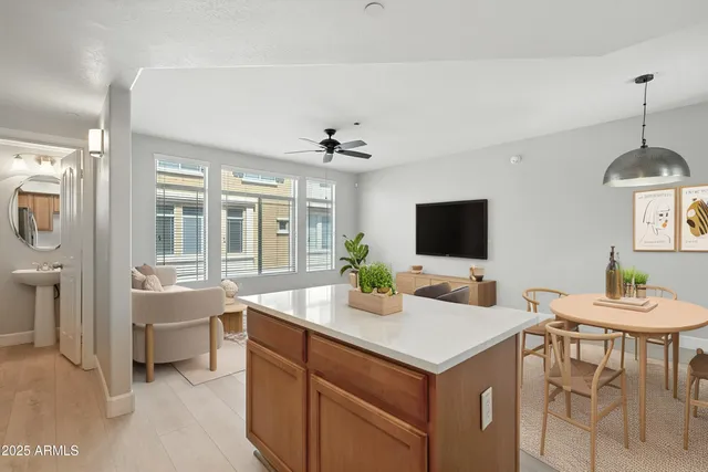 a room with a sink and a flat screen tv
