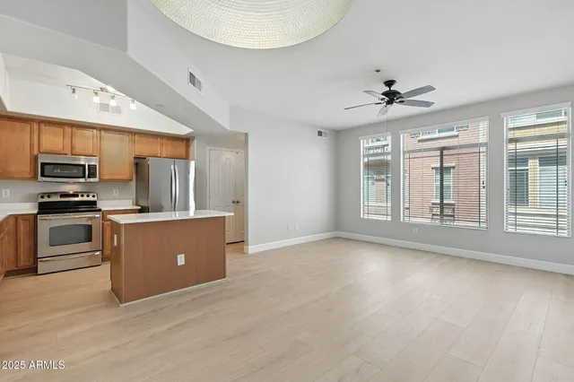 a view of kitchen with sink microwave and refrigerator