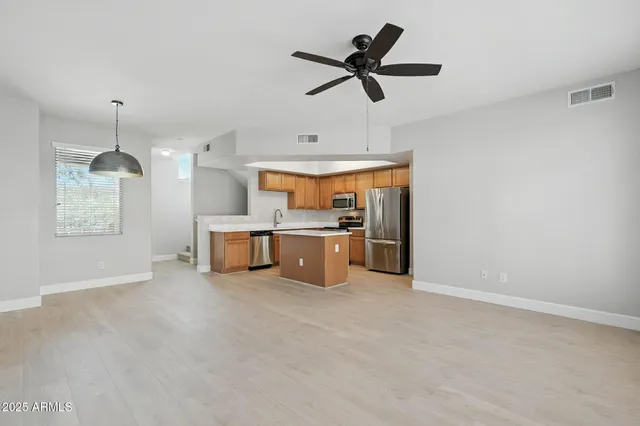 a view of a kitchen with a sink wooden floor and a window