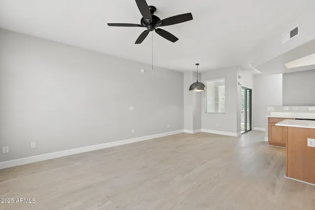 an empty room with a kitchen and a sink