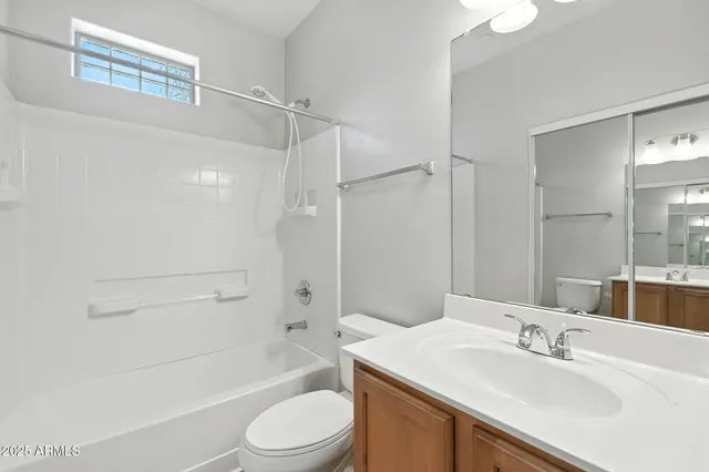 a bathroom with a sink toilet vanity and shower