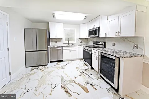 a kitchen with a sink stove and microwave