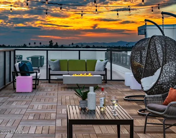 a view of a balcony with chairs and a potted plant