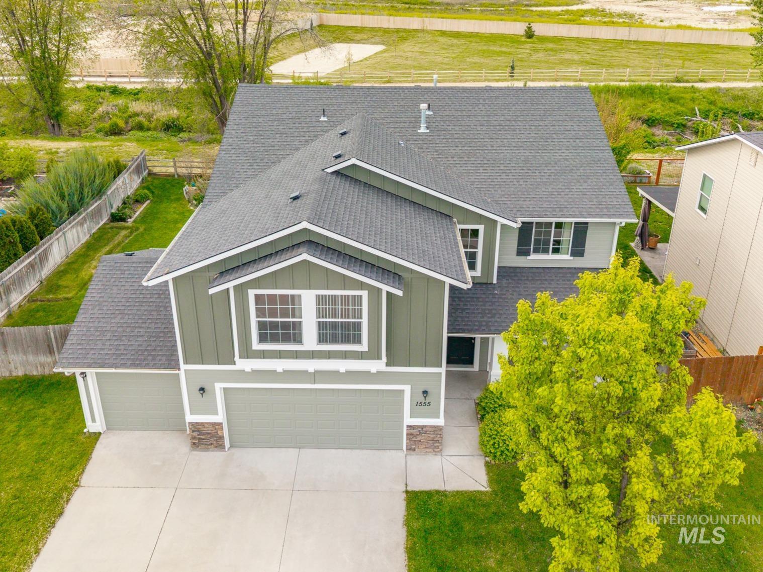 1555 Condor Drive Middleton, ID 83644 - Photo 48 of 50 Two-story residence featuring a dark asphalt shingle roof and a two-tone green siding exterior