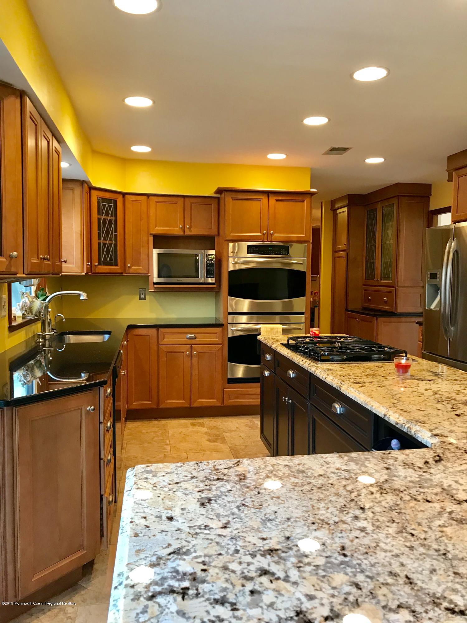 17 Dunhill Road Jackson, NJ 08527 - Photo 11 of 28 a kitchen with stainless steel appliances granite countertop a sink stove and refrigerator