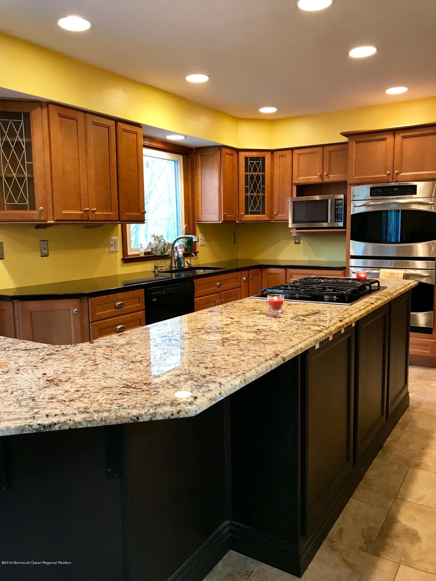 17 Dunhill Road Jackson, NJ 08527 - Photo 12 of 28 a kitchen with stainless steel appliances granite countertop wooden cabinets counter top and stove