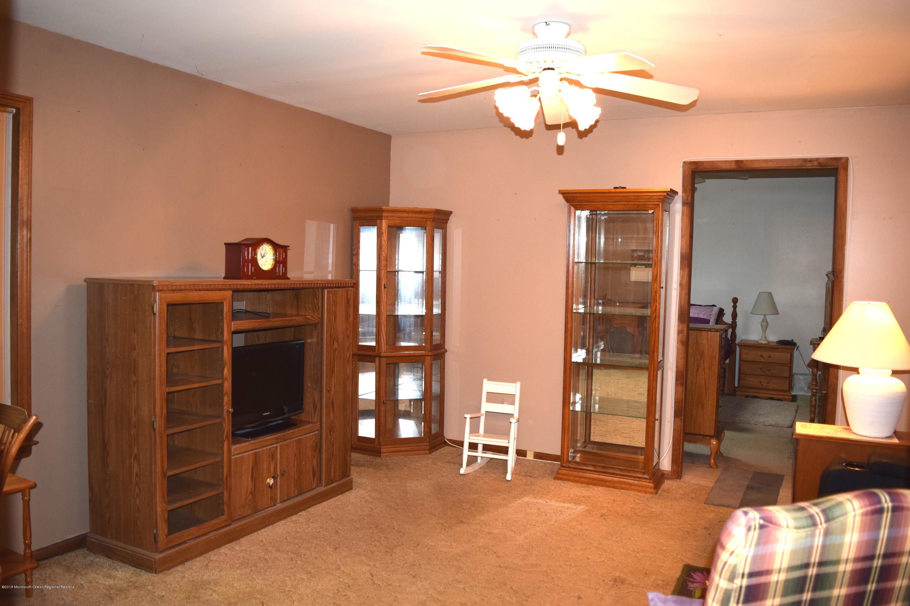 17 Dunhill Road Jackson, NJ 08527 - Photo 14 of 28 a living room with furniture a chandelier and a window
