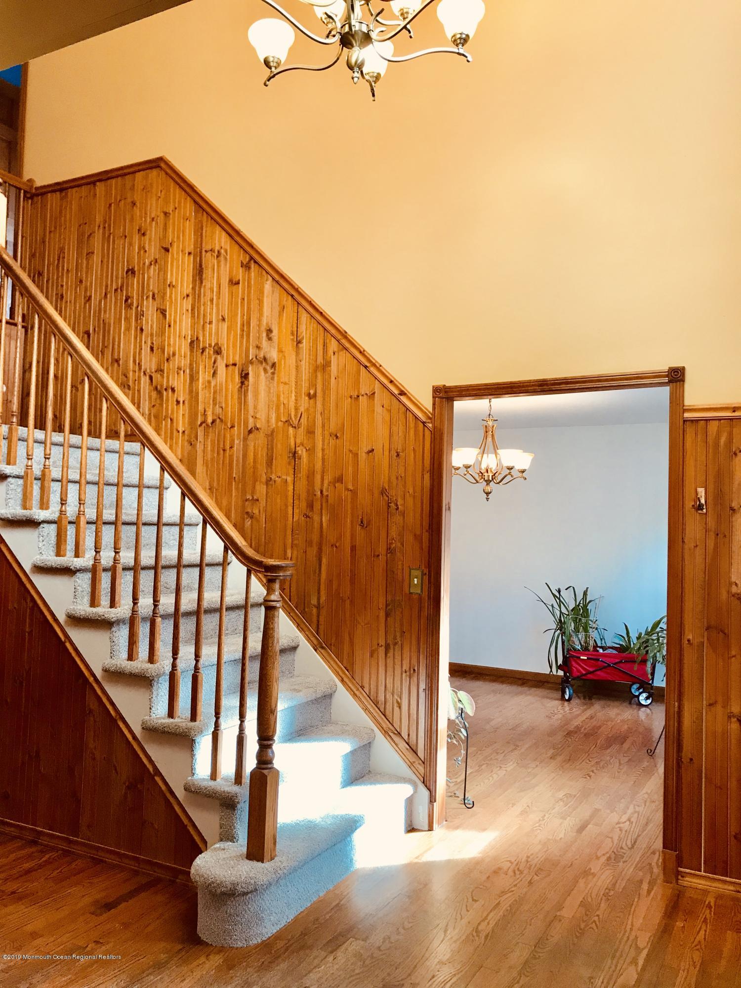 17 Dunhill Road Jackson, NJ 08527 - Photo 3 of 28 a view of staircase with wooden floor and a potted plant
