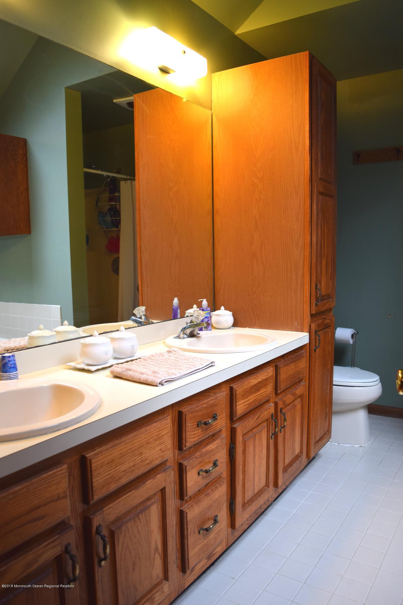 17 Dunhill Road Jackson, NJ 08527 - Photo 21 of 28 a bathroom with a granite countertop sink and a toilet