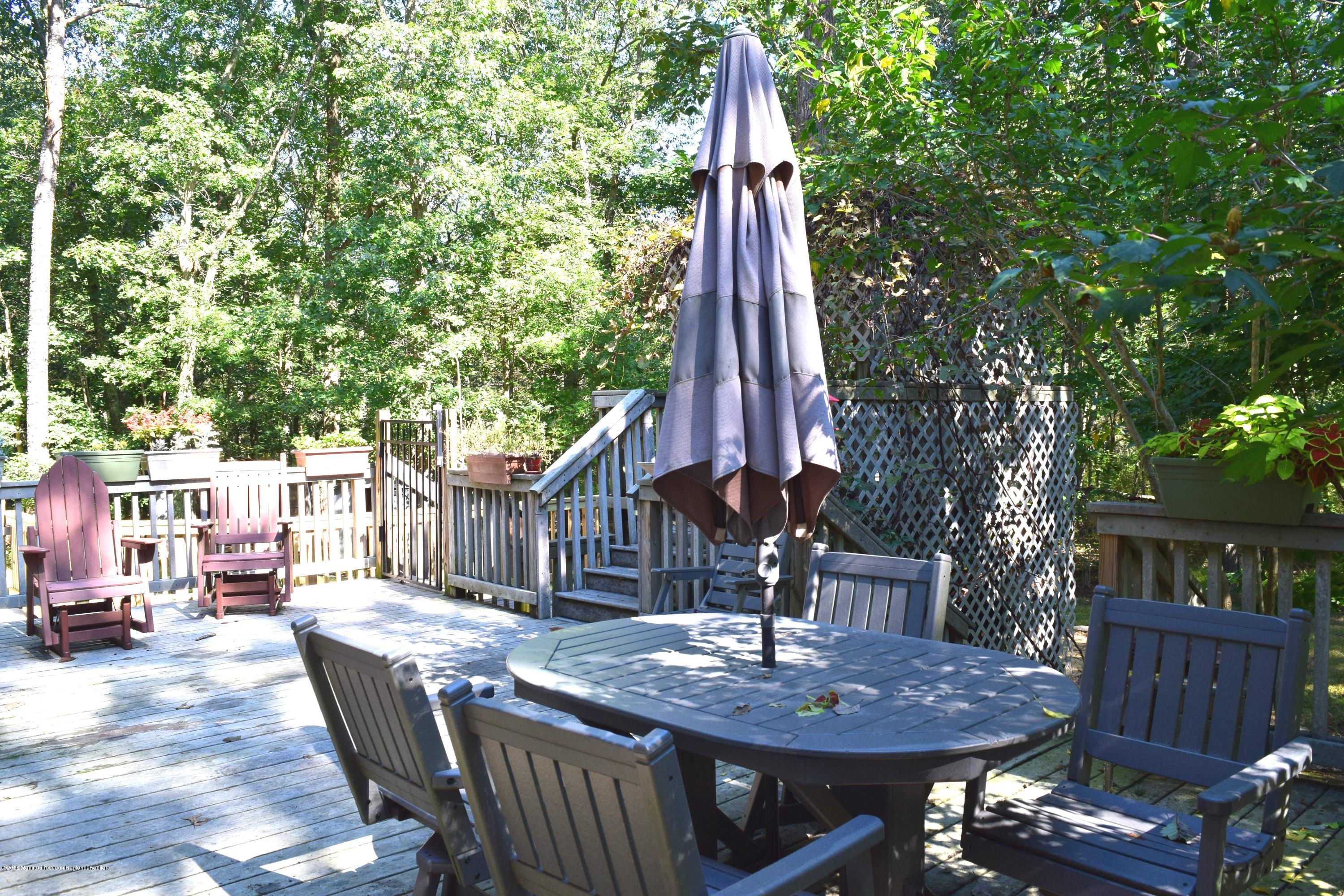 17 Dunhill Road Jackson, NJ 08527 - Photo 22 of 28 a view of a dinning table and chairs in the patio