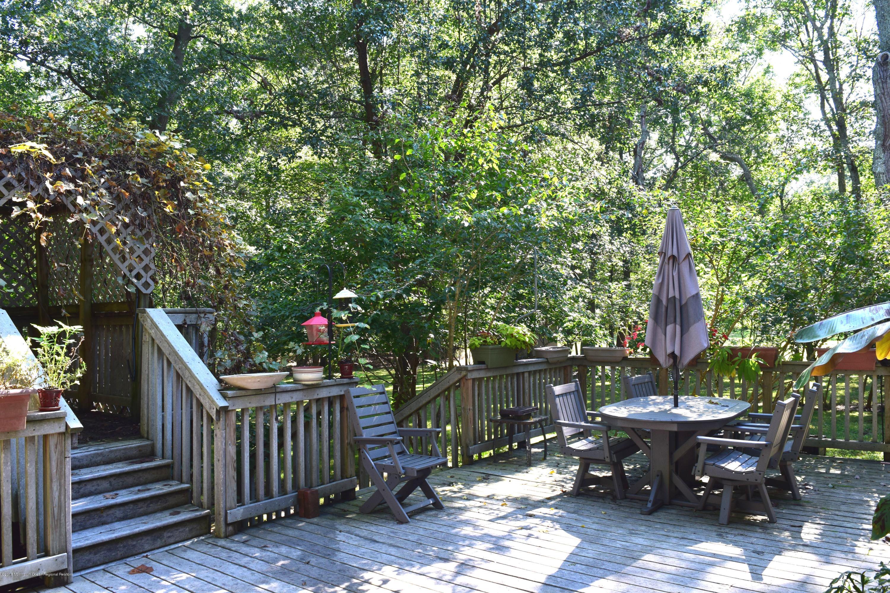 17 Dunhill Road Jackson, NJ 08527 - Photo 23 of 28 a backyard of a house with table and chairs