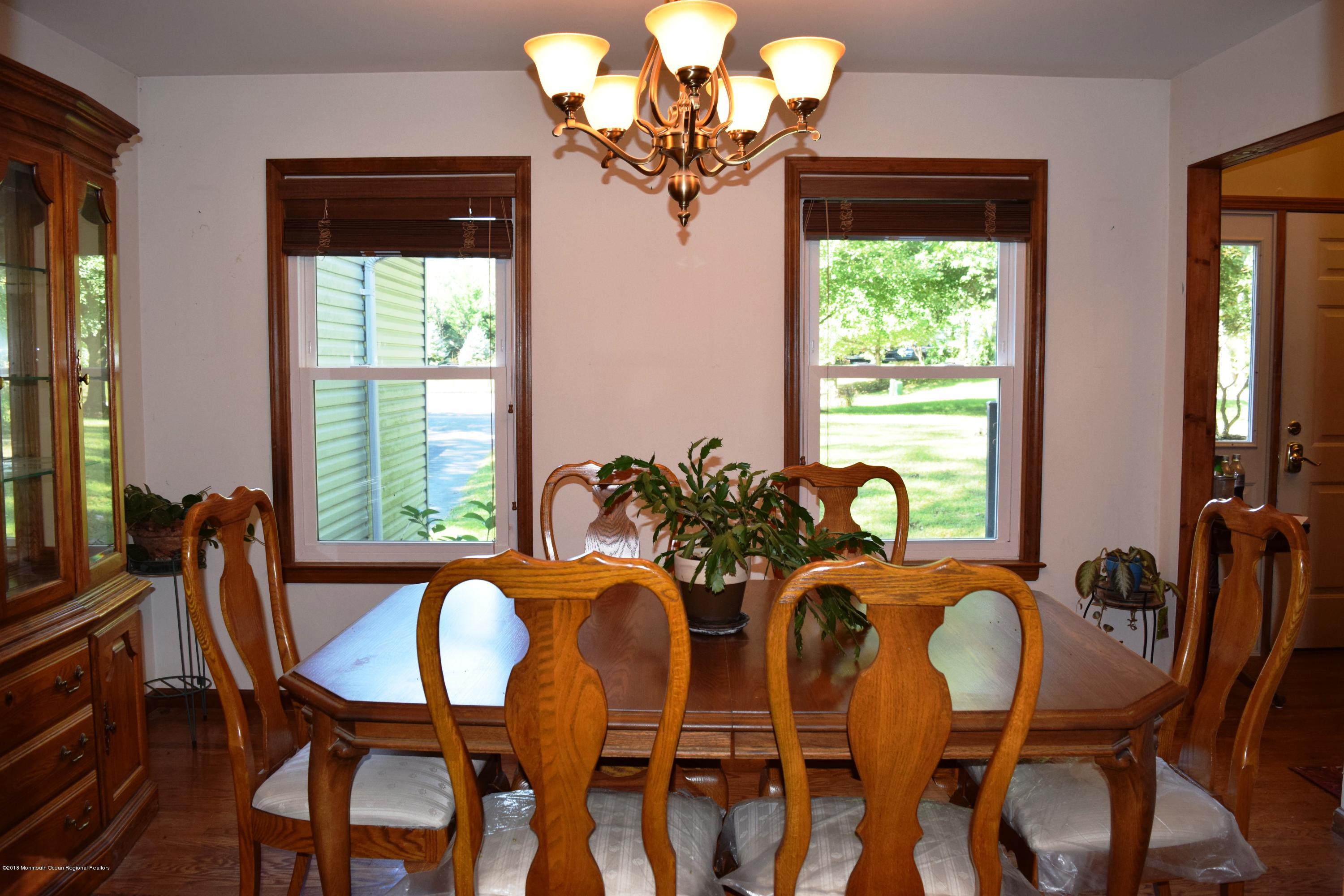 17 Dunhill Road Jackson, NJ 08527 - Photo 6 of 28 a dining room with furniture and a chandelier