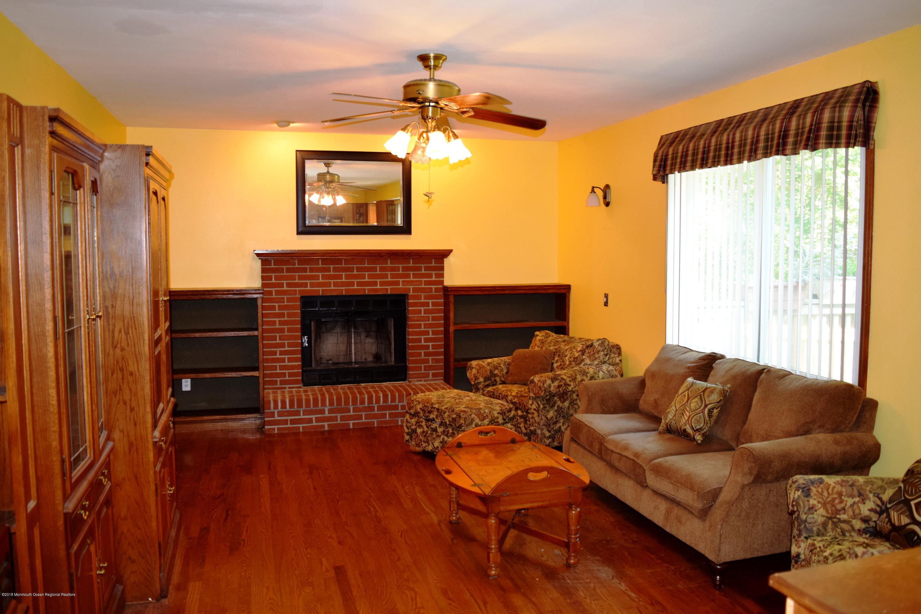 17 Dunhill Road Jackson, NJ 08527 - Photo 7 of 28 a living room with furniture and a fireplace